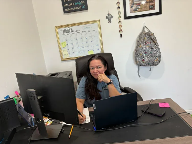Mary Muro at her desk, Muro's Auto Body